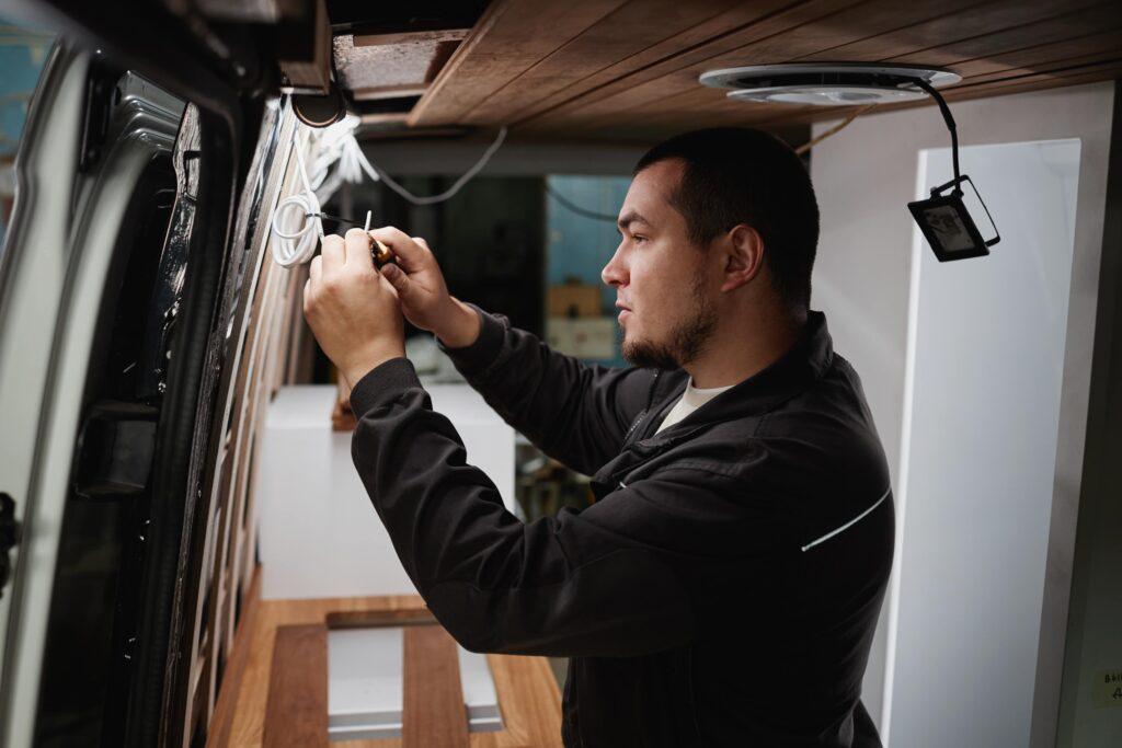 Man fixing a Bespoke Camper